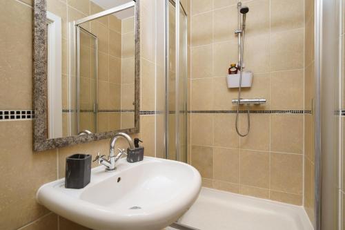 a bathroom with a sink and a shower at St George Wharf in London