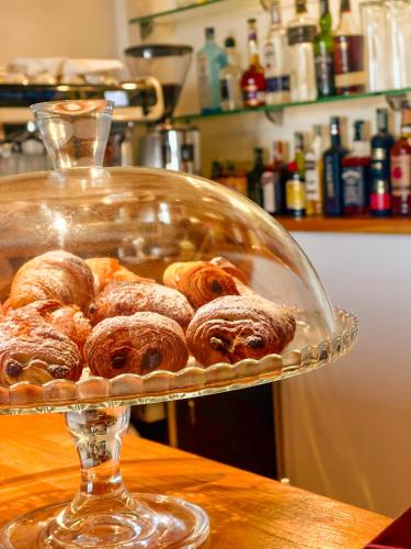 a glass tray of donuts on a table at Hotel Europa in Taranto