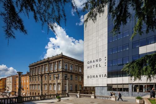 a building with a sign on the side of it at Grand Hotel Bonavia in Rijeka