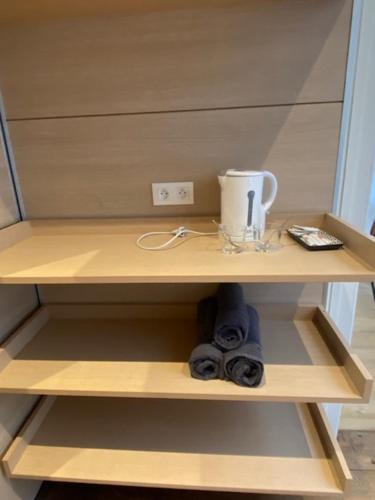 a shelf with a coffee maker and a cup on it at Chez Victor H in Amiens