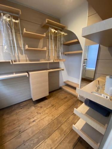 an empty closet with wooden floors and shelves at VICTOR HUGO in Amiens