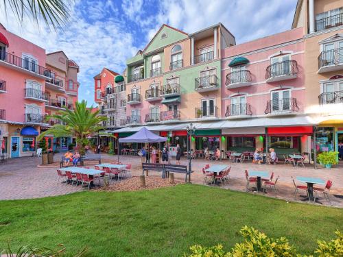 a group of buildings with tables and chairs in a courtyard at 851 Cinnamon Beach in Palm Coast