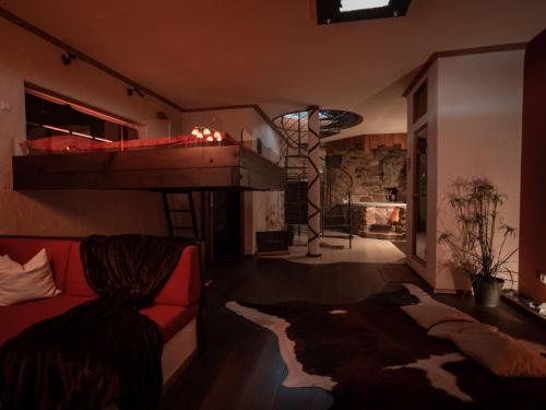 a living room with a couch and a loft bed at Holiday home with whirlpool and sauna in Viechtach in Viechtach