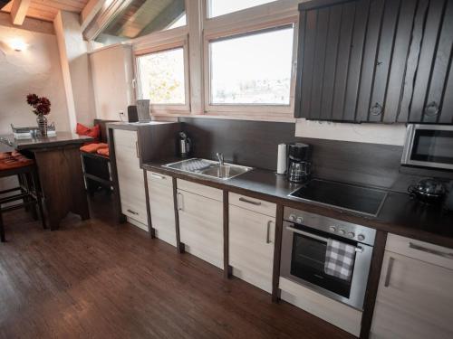 a small kitchen with a sink and a stove at Holiday home with whirlpool and sauna in Viechtach in Viechtach