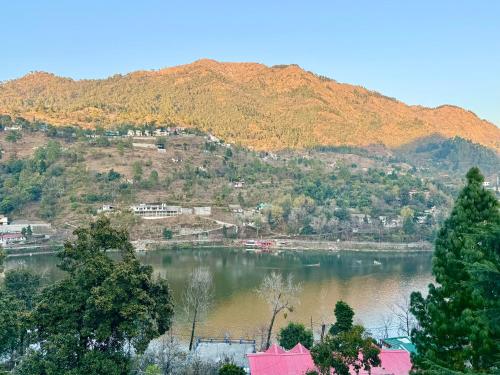 a view of a lake in front of a mountain at Wanna Stay Bhimtal in Bhīm Tāl