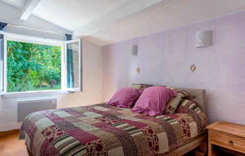 a bedroom with a bed with a blanket and a window at Gorgeous Home In Miramas in Miramas
