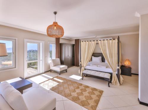 a living room with a bed and a couch at Hill House Adult Only in Kaş