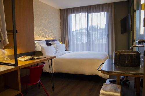 a hotel room with a large bed and a window at Letoh Letoh San Sebastián in Donostia-San Sebastián
