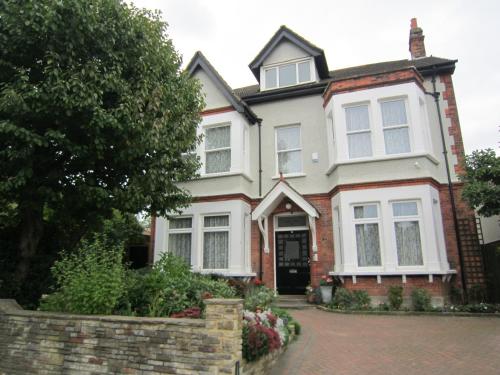 a large house with a brick driveway at Croham Park B&B - Free Parking & Wi-Fi in Croydon