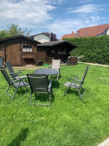 a group of chairs and a table in the grass at Haus Ostwind - Wohnung 2 in Dahme