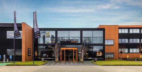 a large building with a sign that reads post union at Postillion Hotel Deventer in Deventer
