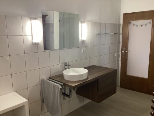 a bathroom with a sink and a mirror at Ferienwohnung Friedsam in Niederzissen