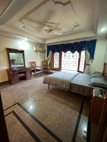 a bedroom with a bed and a mirror and a piano at STONEROCK CASTLE in Hyderabad
