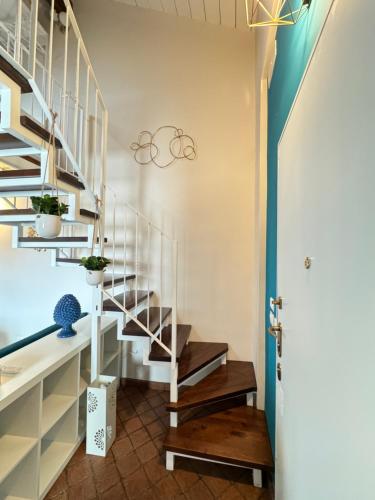 a staircase in a home with a white stair case at Al Campanile in Nicolosi