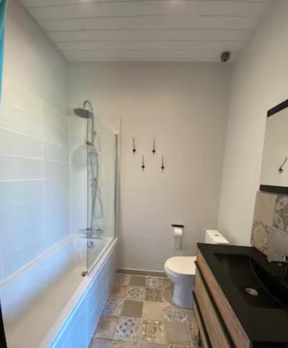 a bathroom with a tub and a toilet and a sink at Studio New-York à Old School à l'ile d'yeu in Port-Joinville