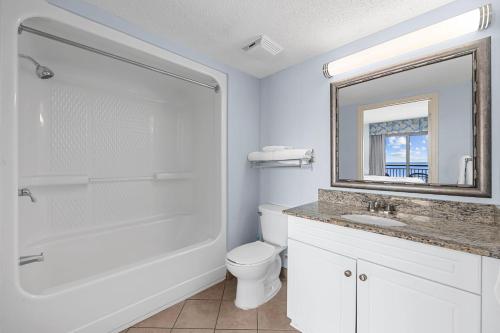 a bathroom with a shower and a toilet and a sink at Ocean View Blues- Caribbean Resort 7th fl in Myrtle Beach