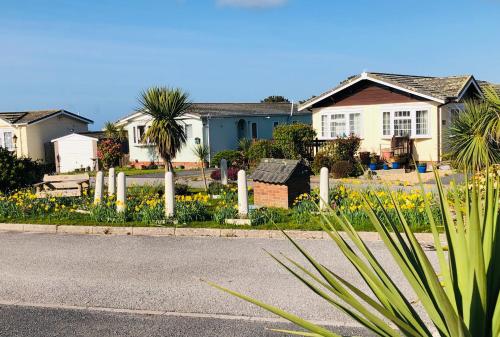 a house with a fence and flowers in the street at Fresh 4 Bed Coastal Home nr Padstow in Padstow