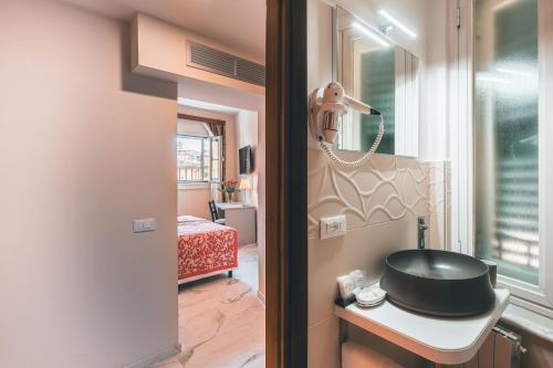 un bagno con lavandino e telefono su un tavolo di Hotel Palazzo Benci a Firenze