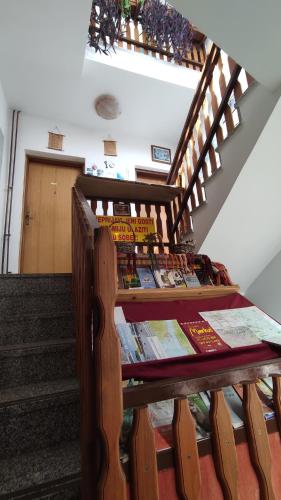 a table with books on it next to some stairs at Mirna noć in Zagreb