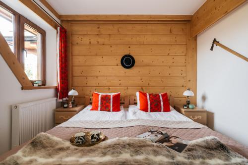 a woman laying on a bed in a bedroom at Apartament Skibówki by LoftAffair in Zakopane