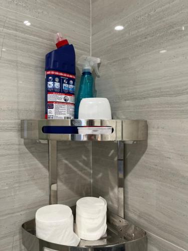 a pile of toilet paper on a shelf in a bathroom at Khu Nghĩ Dưỡng Emerald Golf View in Thuan An