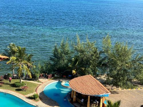 an aerial view of a resort with a swimming pool at The penthouse beachfront in Mombasa