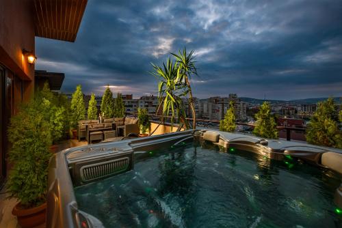 a hot tub on the roof of a house at The Episode - Jacuzzi Penthouses in Cluj-Napoca