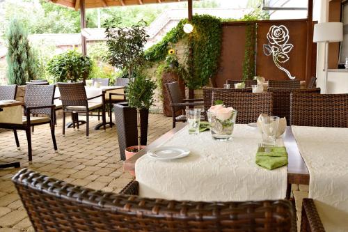 a table with a white table cloth on a patio at Rosenhotel Scherer in Schiffweiler