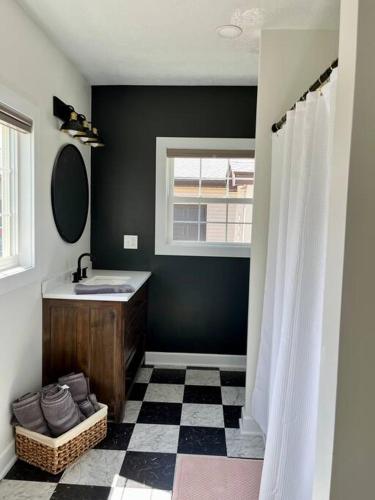 a bathroom with a sink and a mirror at A Winfield Bungalow in Dover