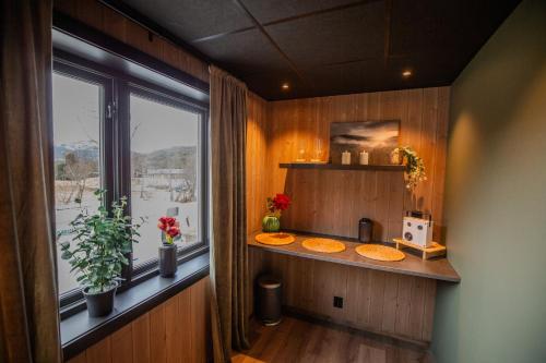 a bathroom with a window and a counter with two sinks at Nordpå Hub in Haltdalen