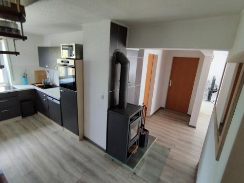 a kitchen with a stove in the middle of a room at Pegasus Bergblick in Heidenheim an der Brenz