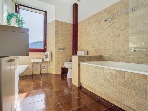 une salle de bain avec une baignoire, des toilettes et un lavabo dans l'établissement Authenticité, jardin, terrasse et vue, à Chanac