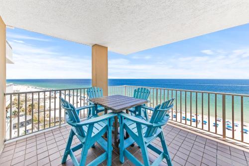 a table and chairs on a balcony with the ocean at Romar Place Unit 904 in Orange Beach