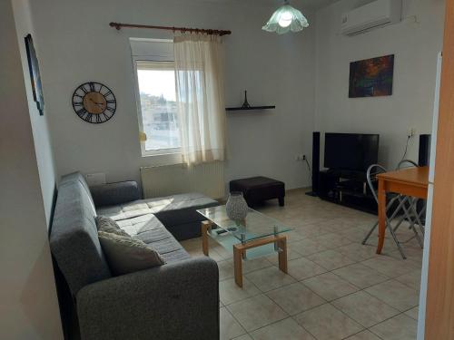 a living room with a couch and a table at Georgios home in Heraklio