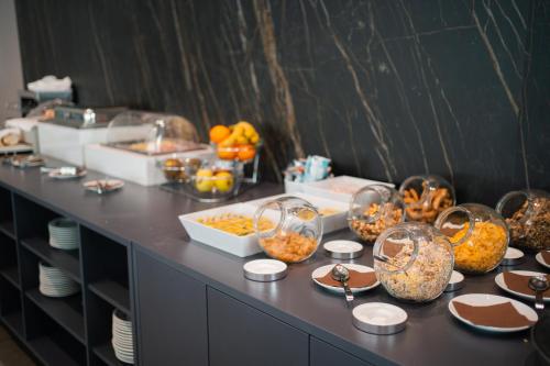 a buffet with many dishes of food on a table at Hotel Principe d'Aragona, Sure Hotel Collection by BW in Modica