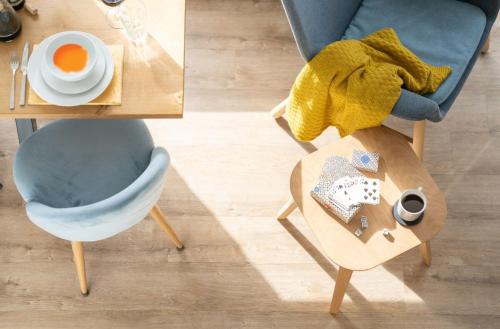 a table with a cup of coffee and a chair at Serene Retreat in Chapel Stile by LetMeStay in Ambleside