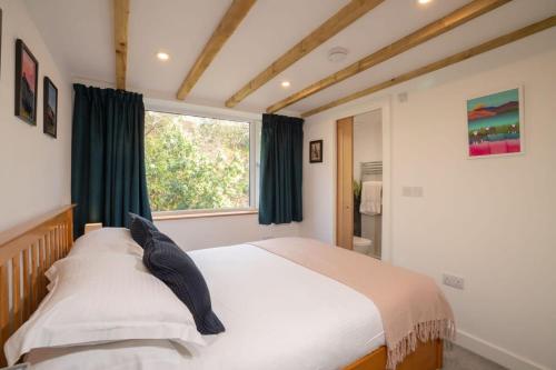 a bedroom with a large bed and a window at Serene Retreat in Chapel Stile by LetMeStay in Ambleside