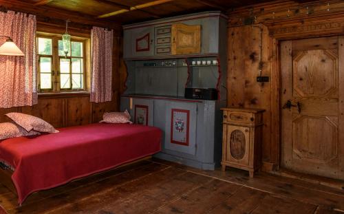 a bedroom with a bed and a stove in a room at Sandrellhaus in Tschagguns