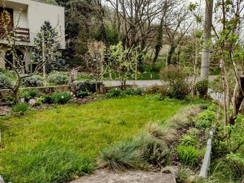a garden in front of a house at WineBerry Apartment in Pavlov