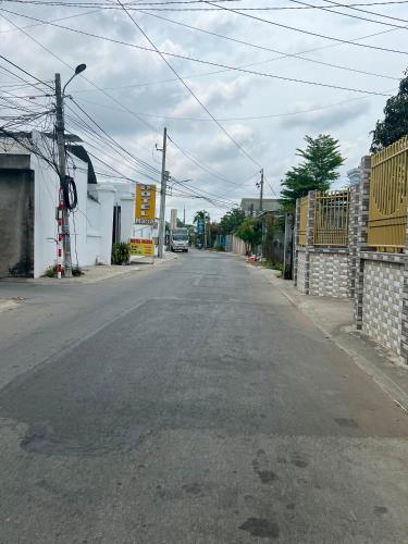 an empty street in a town with a building at Maria Hotel in Ba Tri