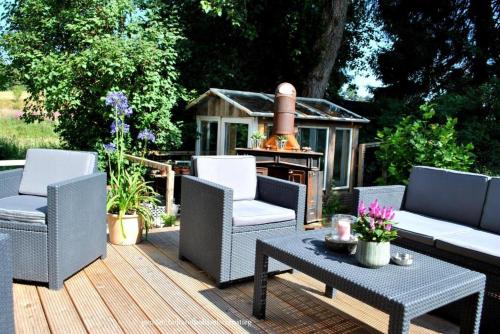 a patio with chairs and a table and a grill at Pension Holl und Boll Am Hexenstieg. in Clausthal-Zellerfeld