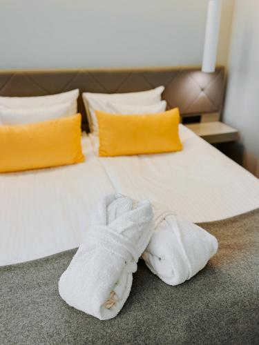 a bed with two white towels on it at ibis Styles Tallinn in Tallinn