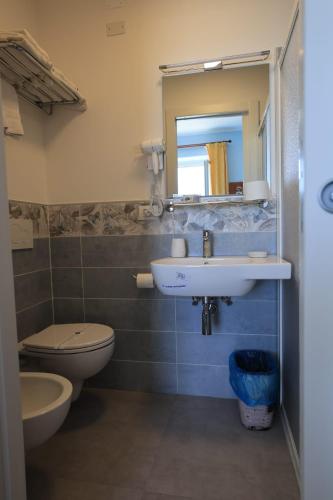 a bathroom with a sink and a toilet and a mirror at Viviani Raffaella in Monterosso al Mare