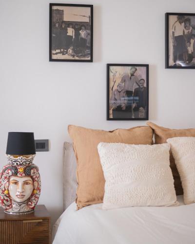 a bedroom with a bed with a vase on a table at Vicoloterzo Suite in Bari