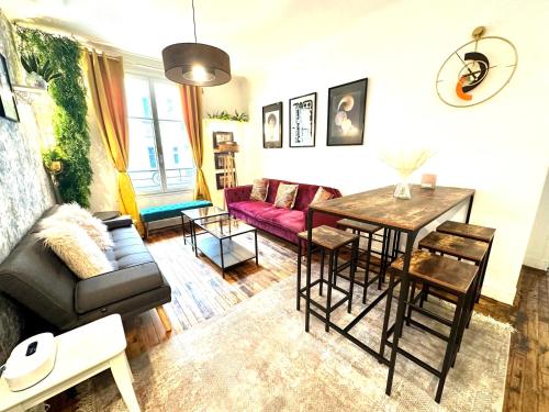 a living room with a couch and a table at Spacieuses Flats Paris Porte de Versailles in Paris