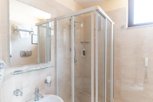 a bathroom with a shower with a sink and a toilet at Hotel Principe d'Aragona, Sure Hotel Collection by BW in Modica