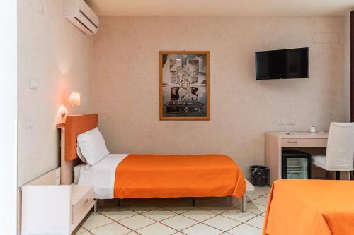 a hotel room with a bed and a desk at Hotel Principe d'Aragona, Sure Hotel Collection by BW in Modica