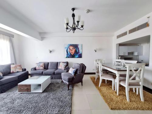 a living room with a couch and a table at Axxodia Residence New Cairo in Cairo