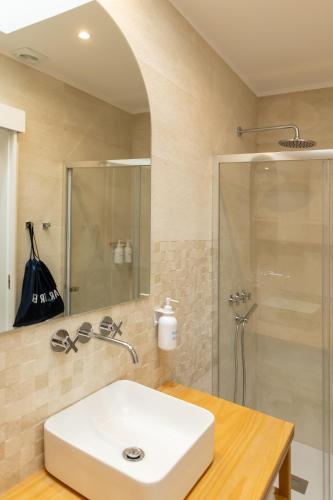 a bathroom with a white sink and a shower at Blue House- am Strand von Vila do Conde, Porto in Vila do Conde