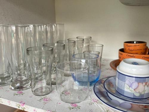a group of clear glasses sitting on a table at Casa do Jardim in Curitiba